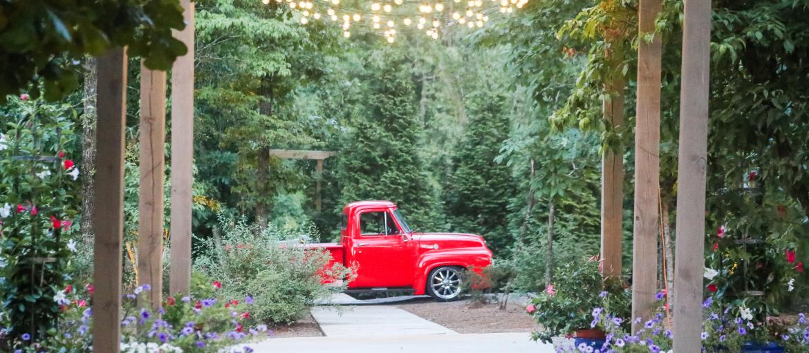 red truck in wooded area for wedding venue with rock bottom pond
